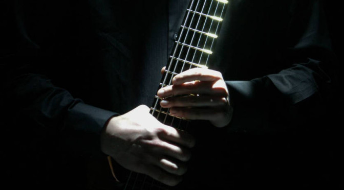Johnny Cox Black Shirt Hands On Bass 1